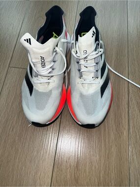 adidas White Running Shoes with Black Stripes and Neon Orange Accents